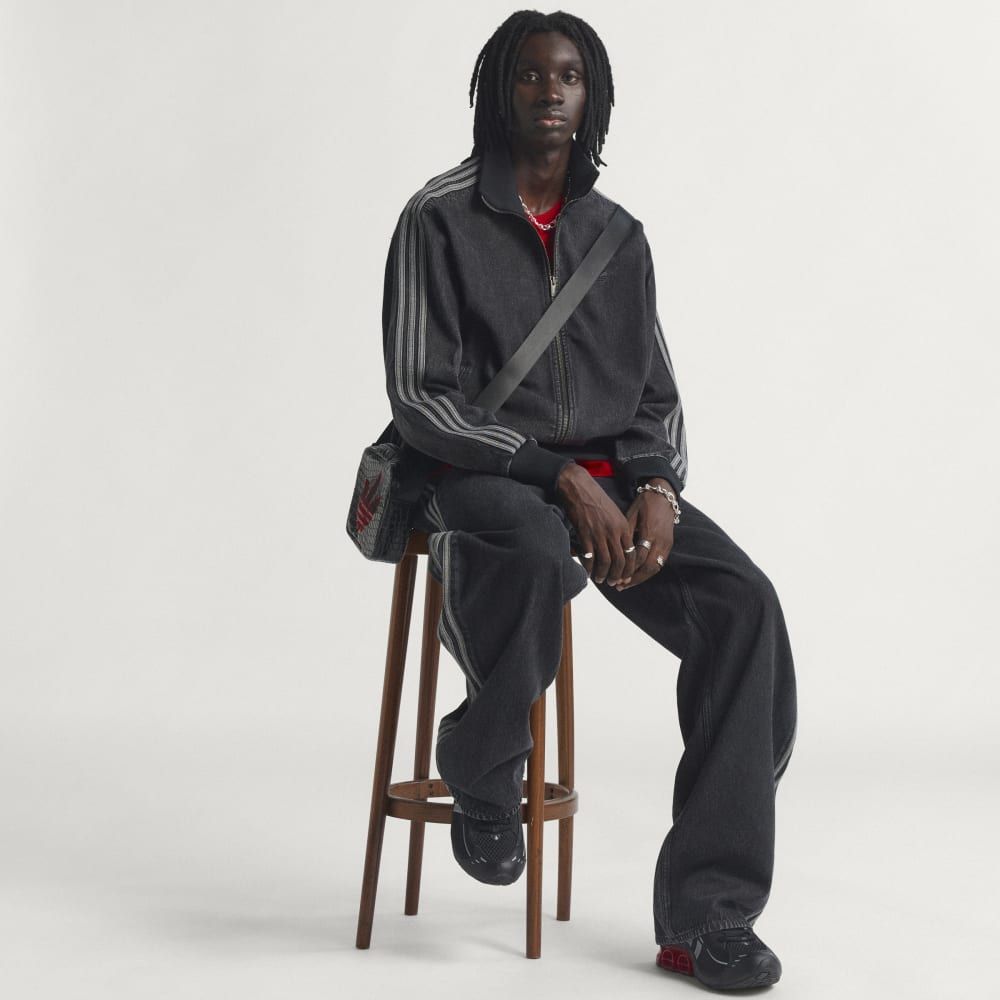 Adidas Adicolor Denim Firebird Track Top in full view, showing tapered sleeves, ribbed detailing, and structured denim construction